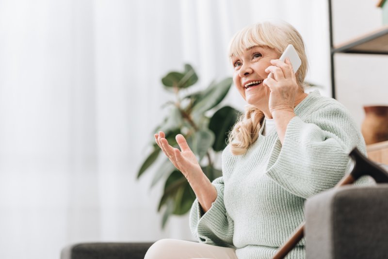 elderly woman on mobile phone talking and smiling