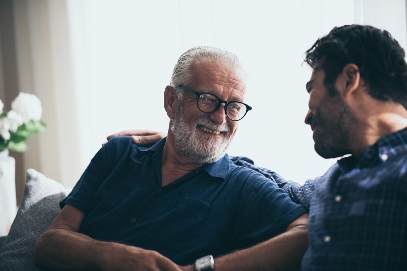 elderly man laughing with son